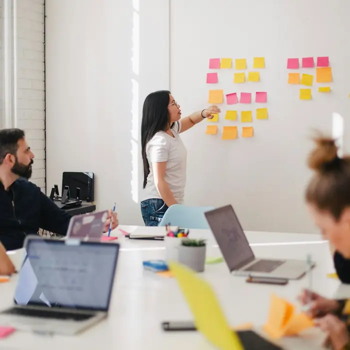 Team workshop with sticky notes on a whiteboard